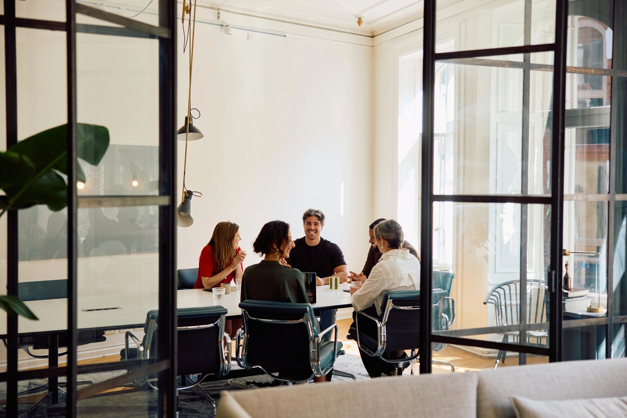 Editorial team collaborating in a modern office meeting